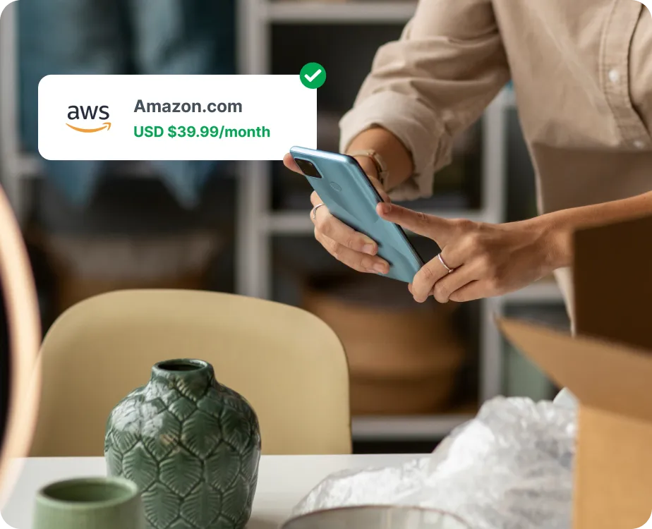 A person holding a camera for taking a photo of a figurine that looks like a flower base.