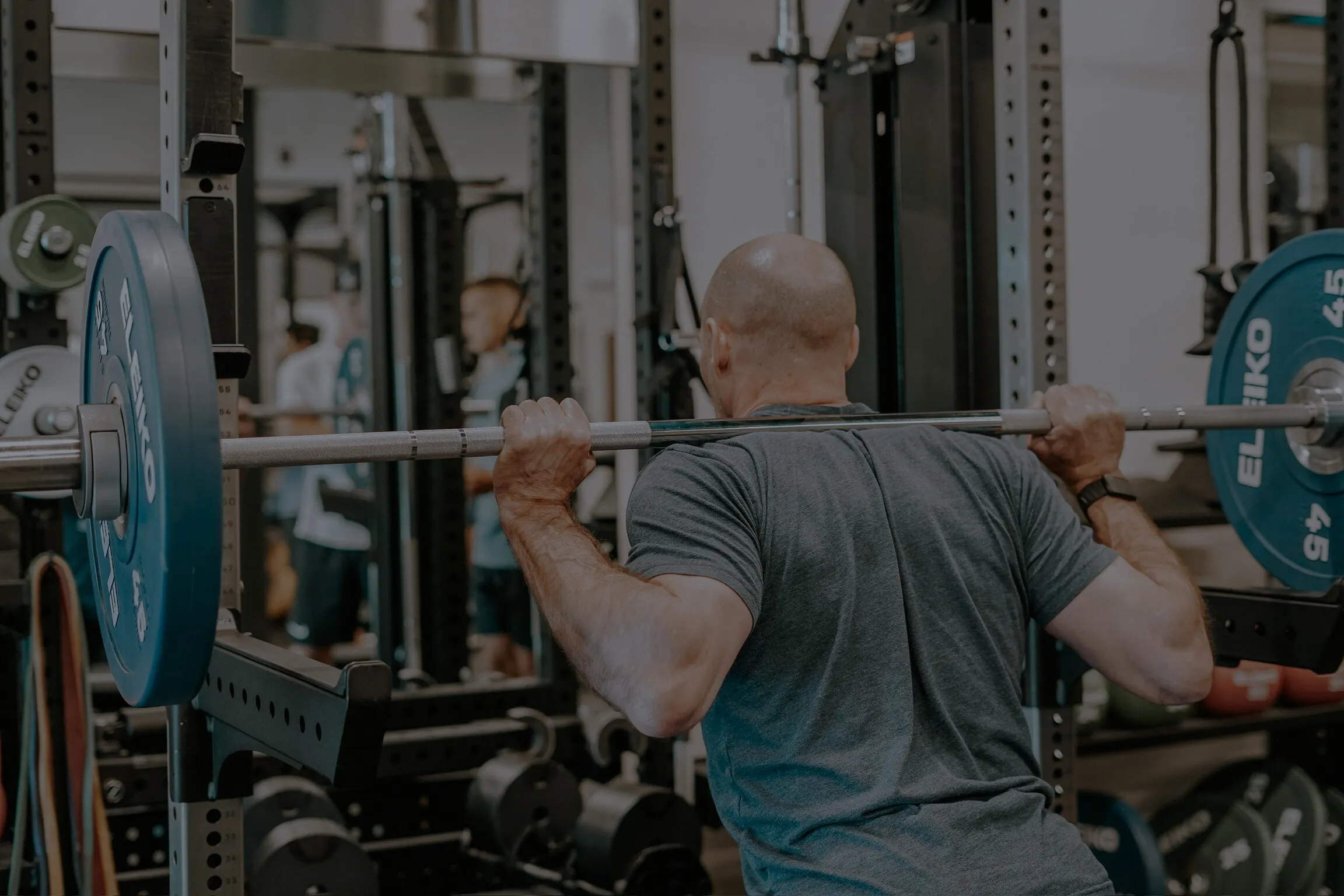 Man lifting weight on his back