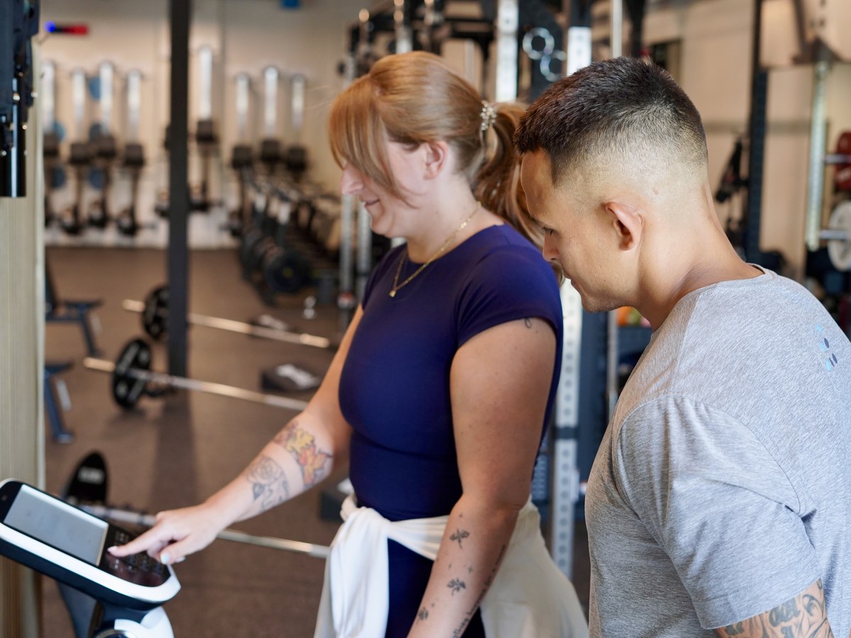 A proof3 coach going through a member's results with her on screen