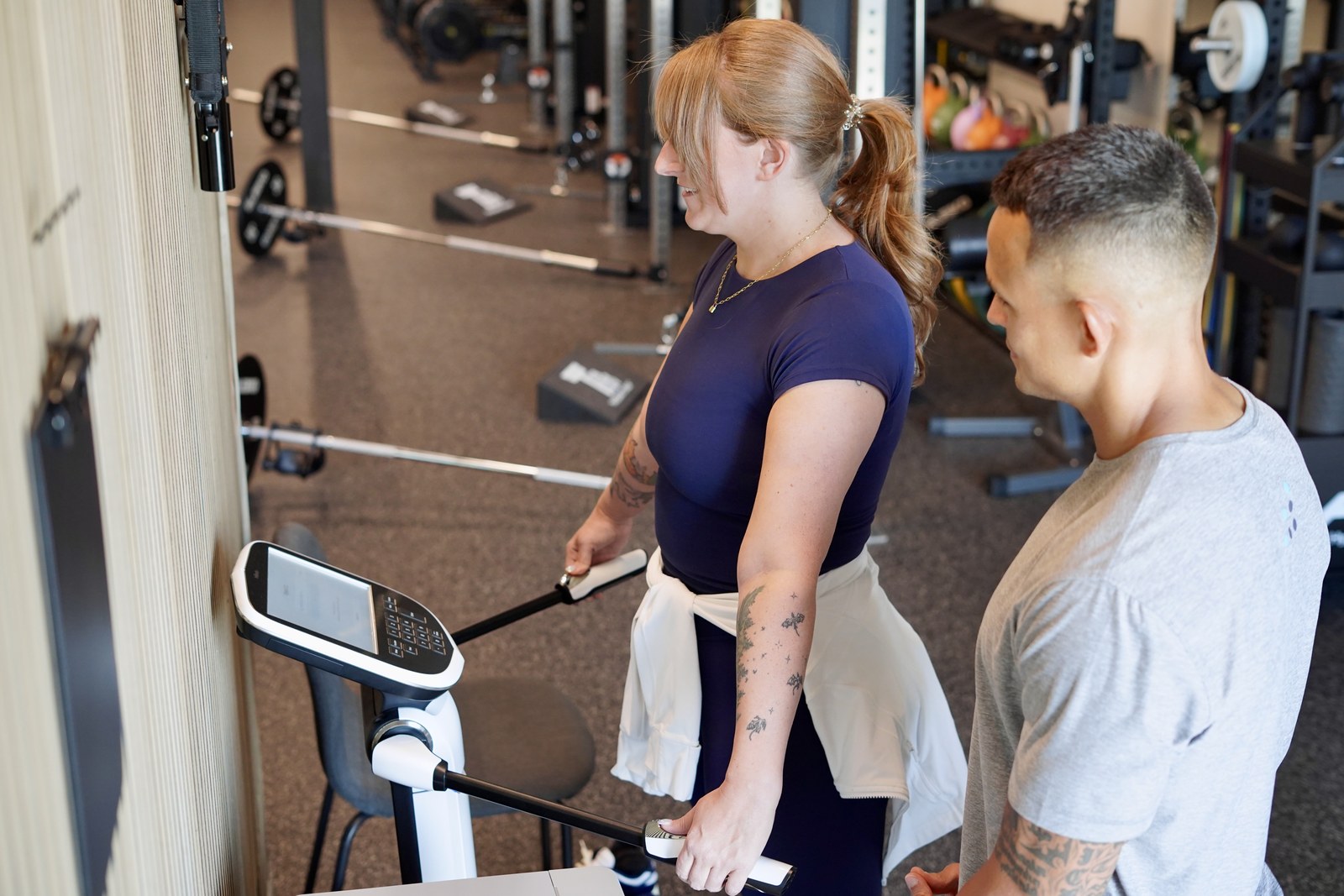 A proof3 coach and a member reviewing body composition results together at proof3 Salt River in Scottsdale