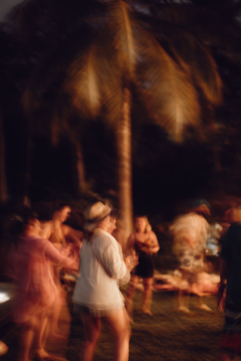 Dancing under the palms at night