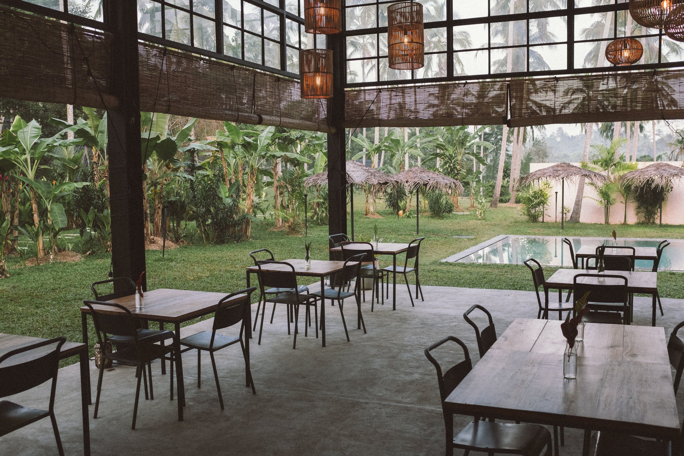 Tables in the PALM Pavilion looking out to the pool