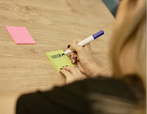 Writing "Innovation" on a sticky notes