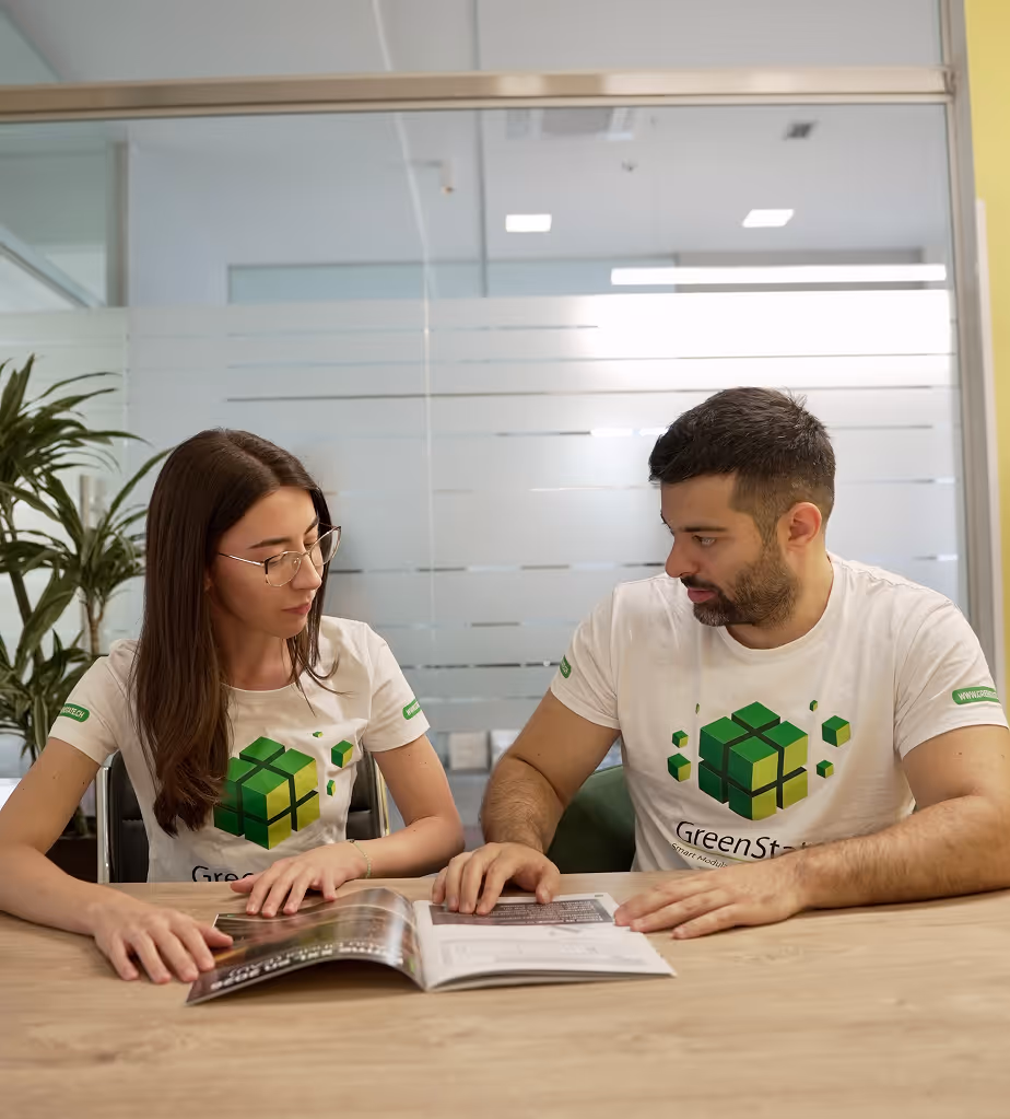 Two employees discussing newsletter