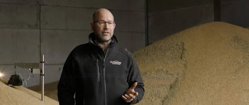 Interview frame: a farm manager talks in a grain store