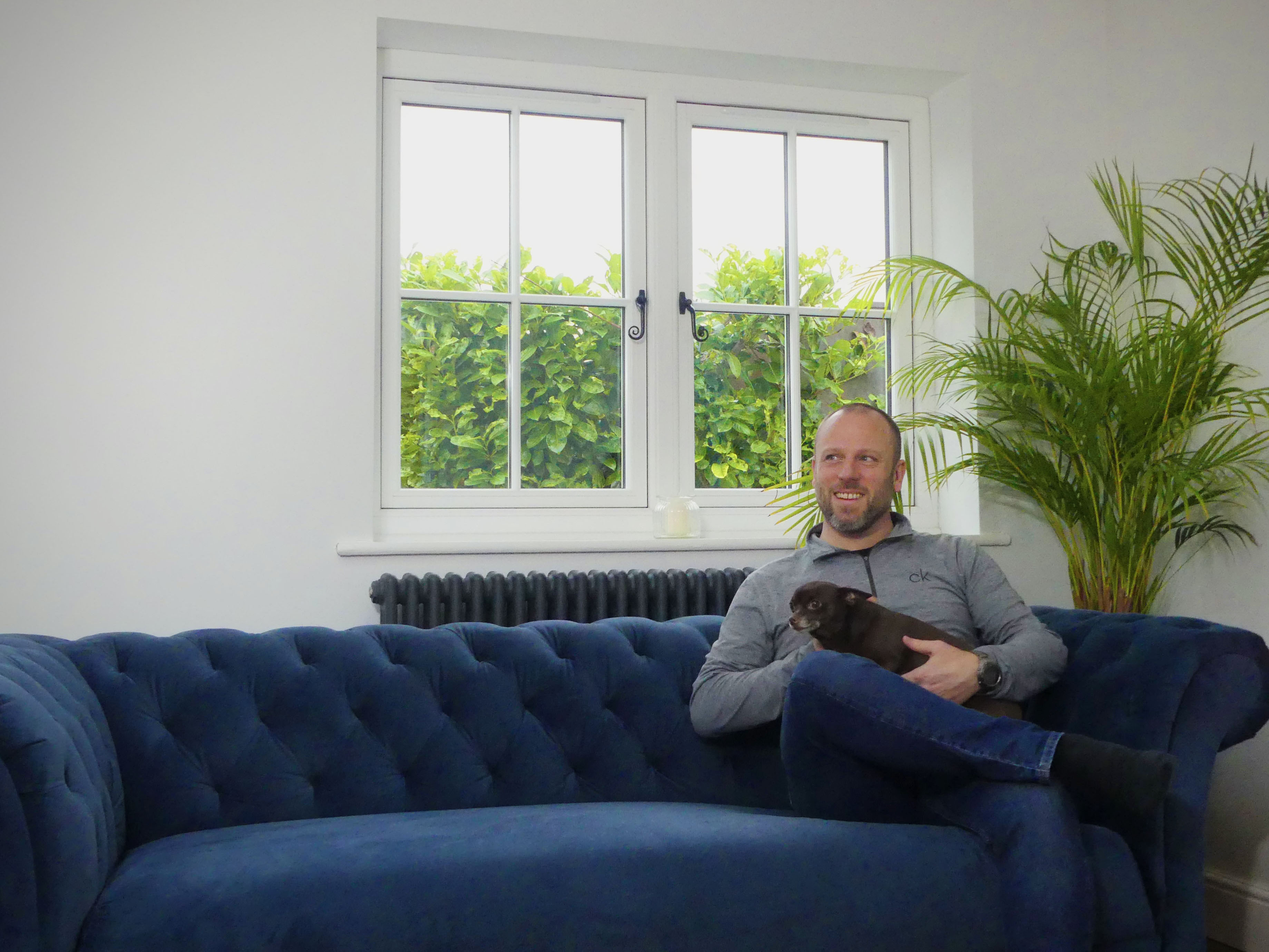 Liam Atkins, smiling UK mortgage expert with dog, providing expert guidance on securing mortgages.