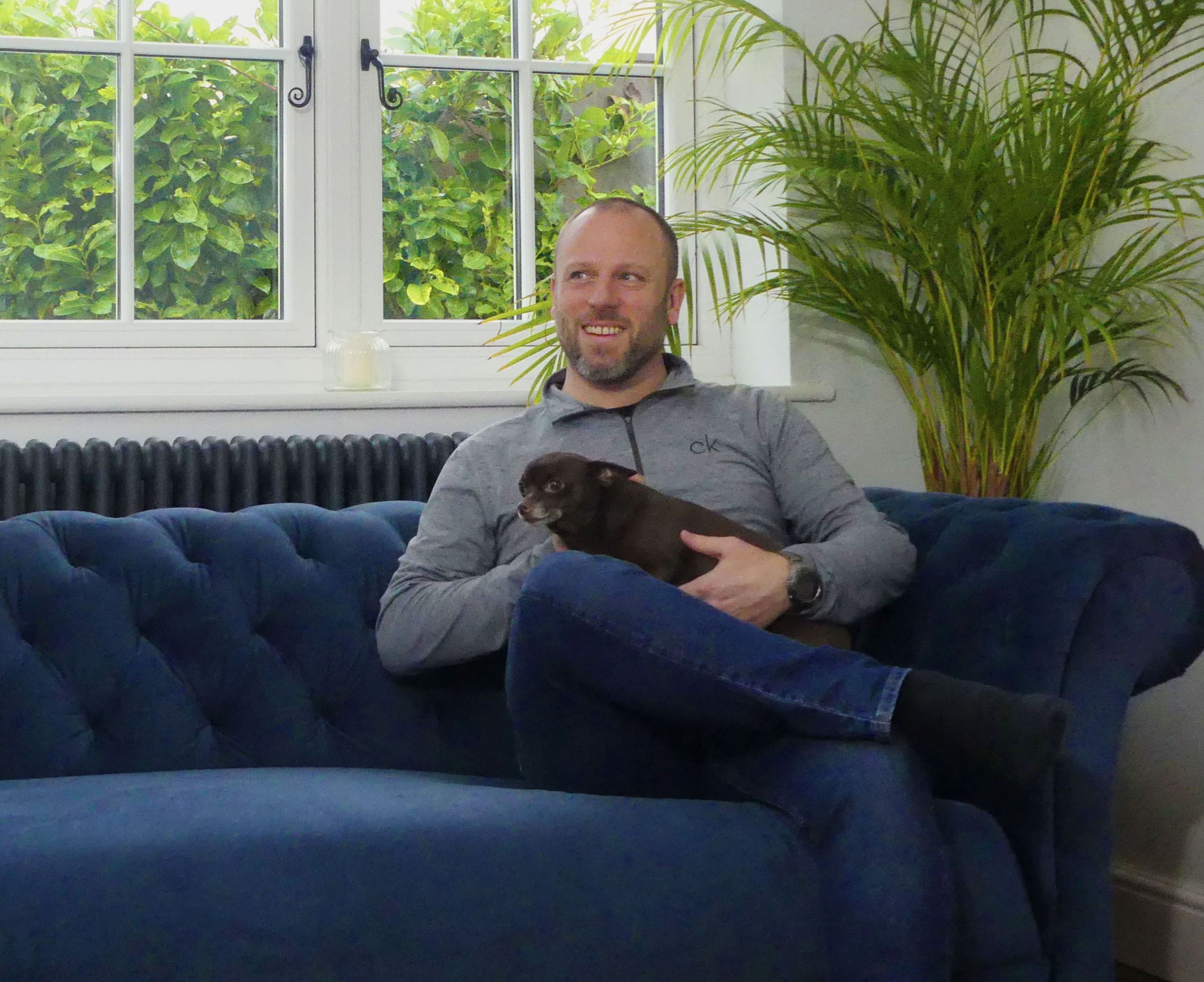 Liam Atkins, smiling UK mortgage expert with dog, providing expert guidance on securing mortgages.