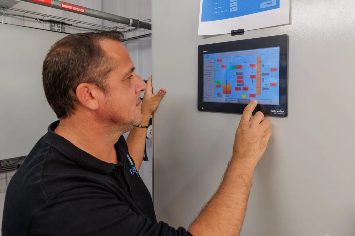 Technician adjusting parameters on touch screen Chrysalis plastic recycling interface