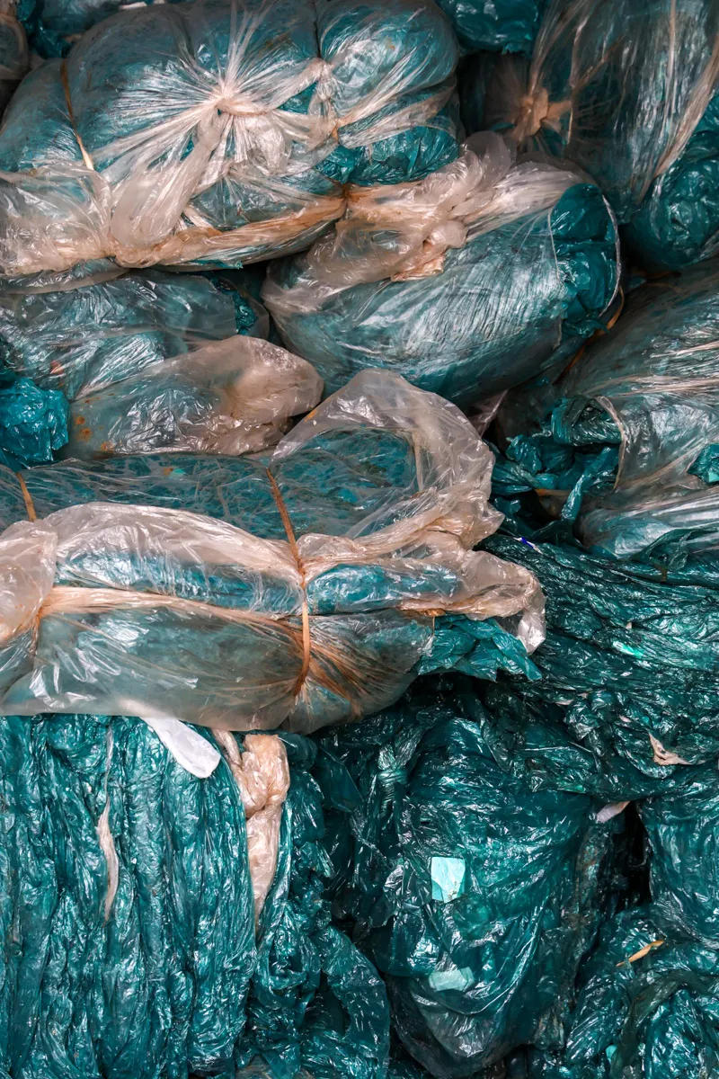 Déchets plastiques compressés transparents et bleus prêts pour recyclage pyrolyse