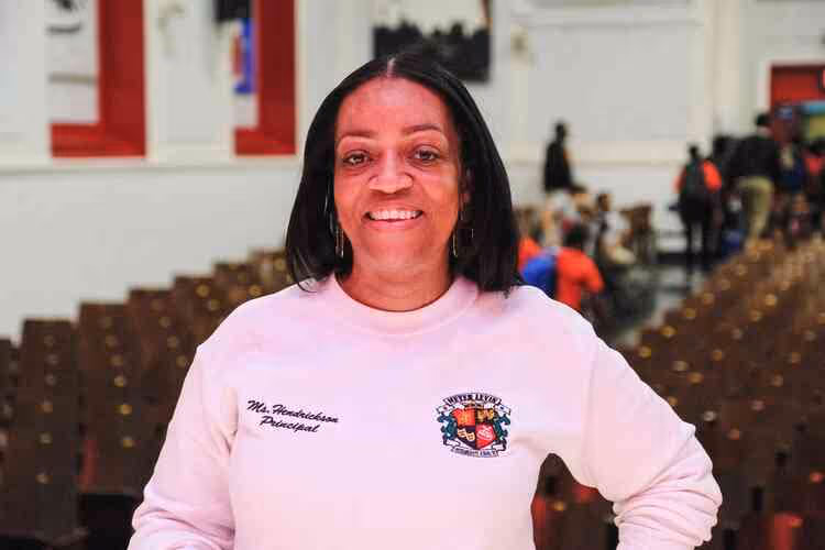 Principal Hendrickson in auditorium sweater