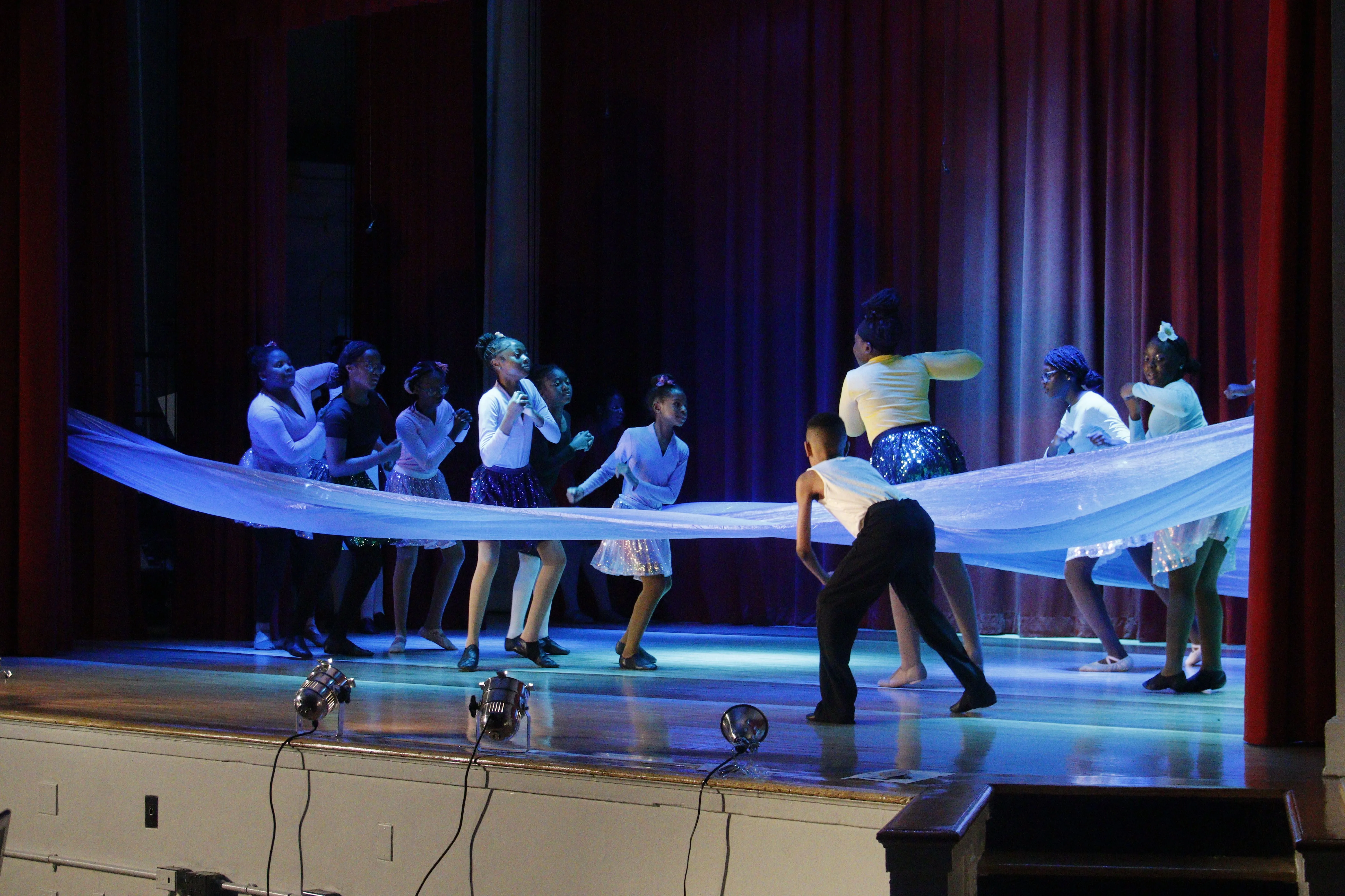 Students stretching near ballet barres