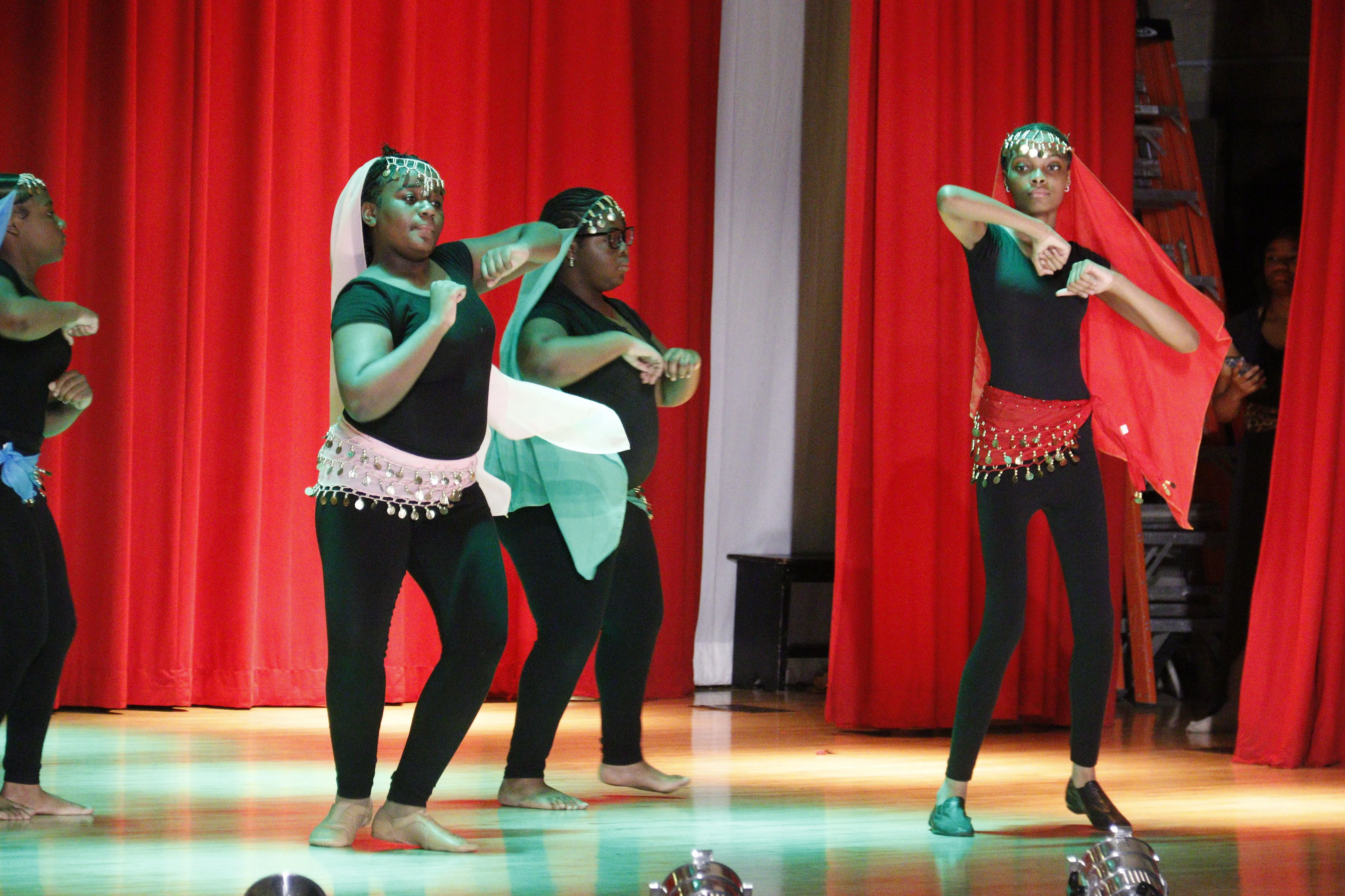 Four dancers performing energetic routine
