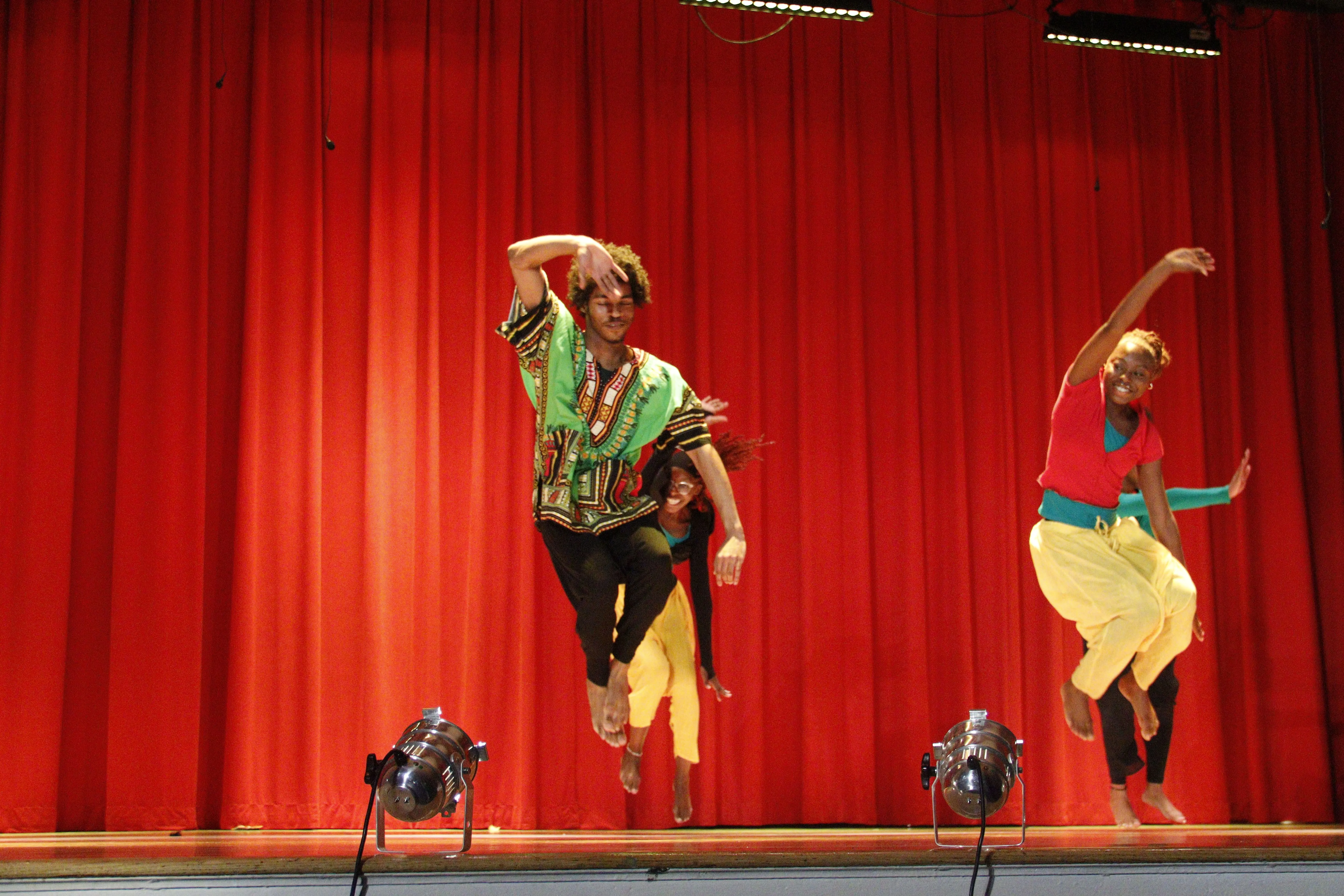 Students performing dynamic dance on stage