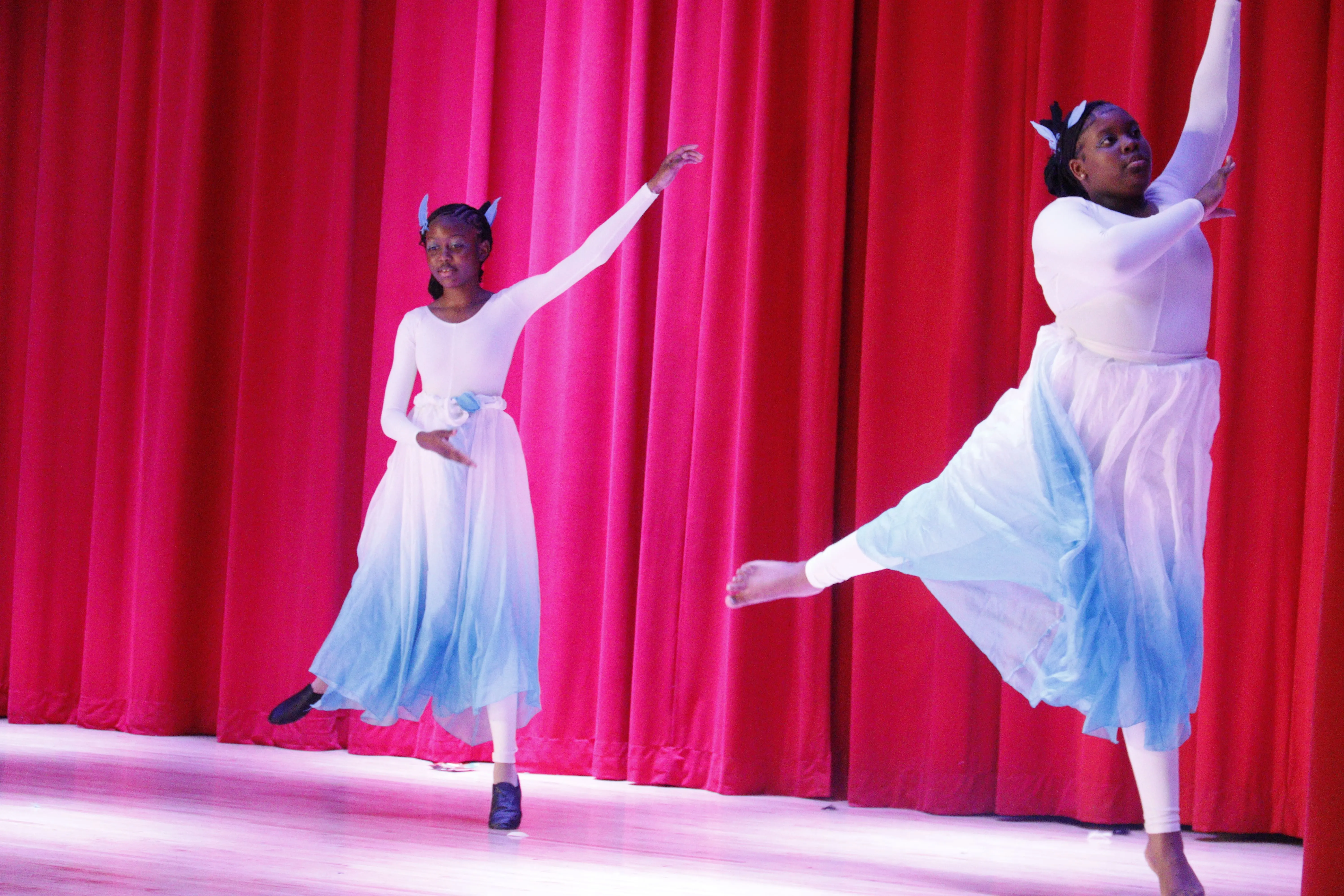 Two dancers in flowing costumes