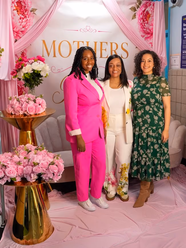 Three women posing together at a school Mothers Day celebration