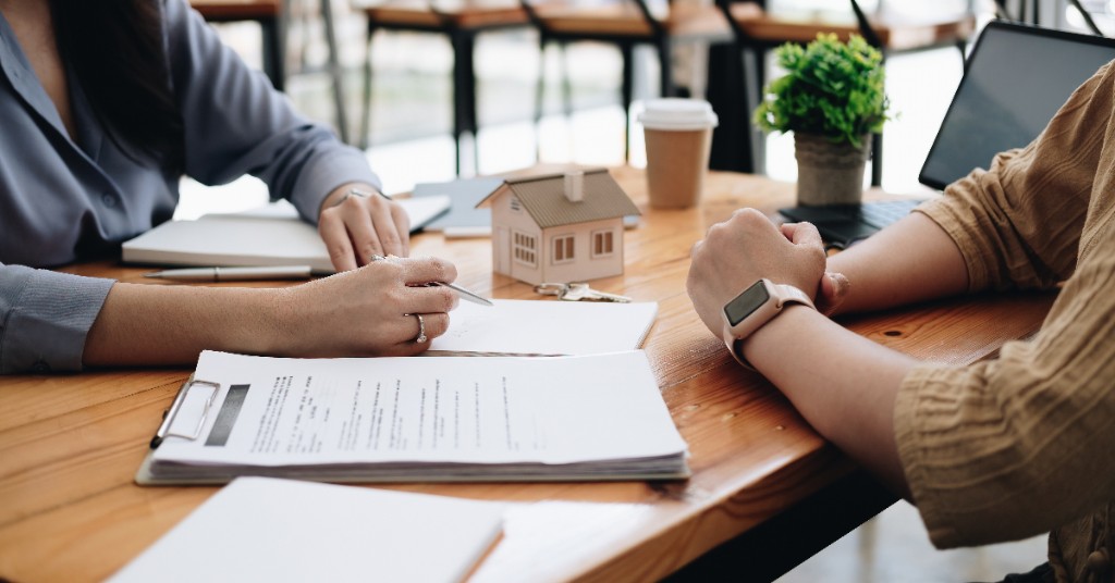 Lending professionals shaking hands on a rental income analysis