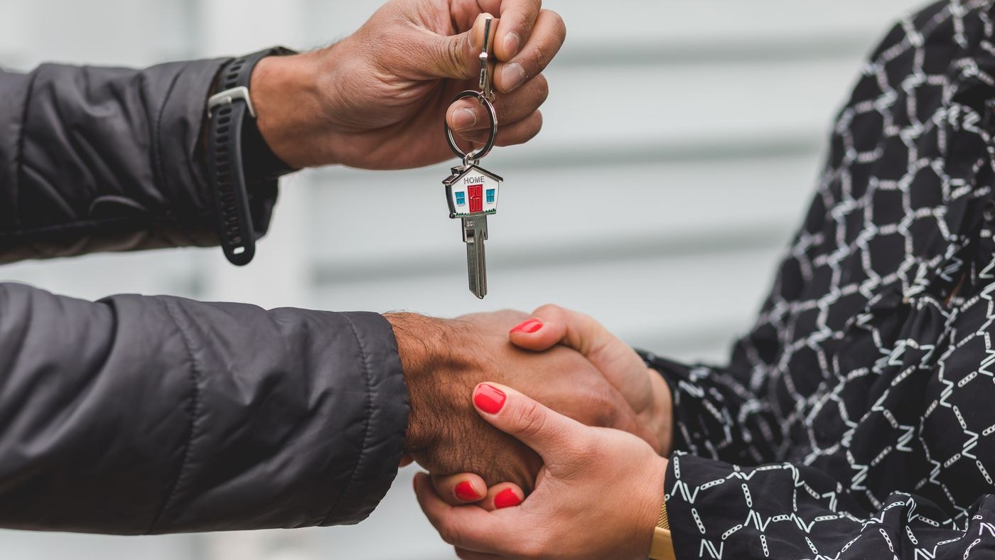 Property manager handing over house keys at a rental property