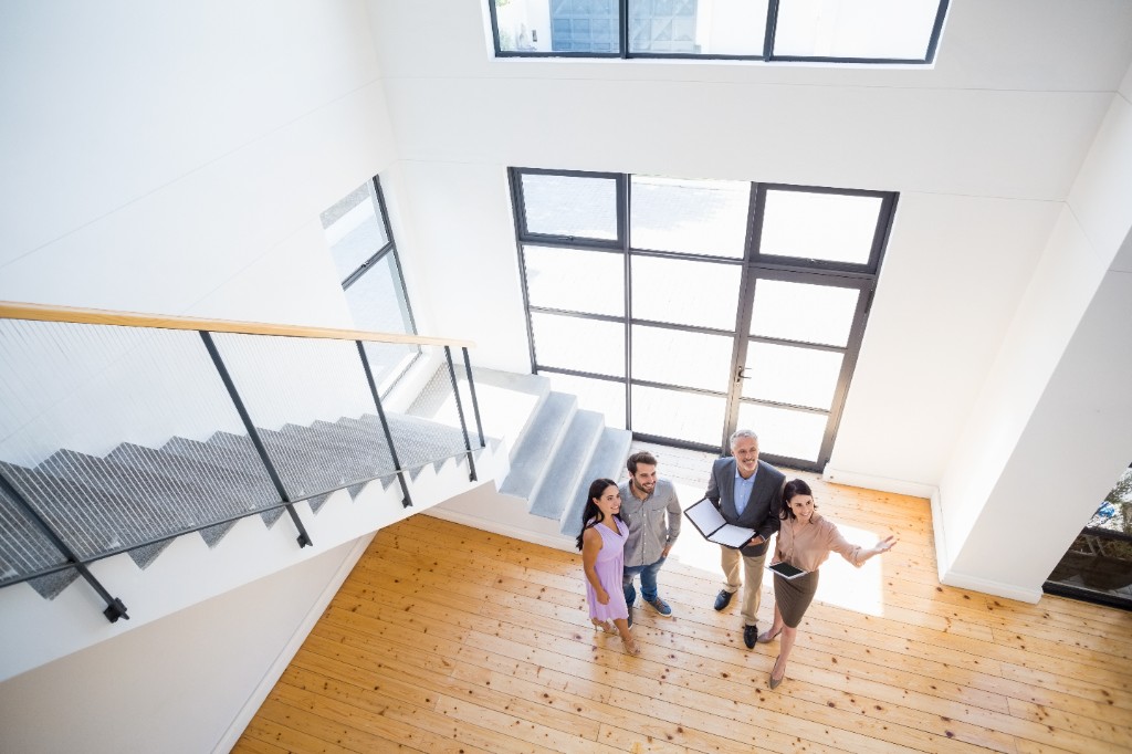 Real estate agent showing property to clients