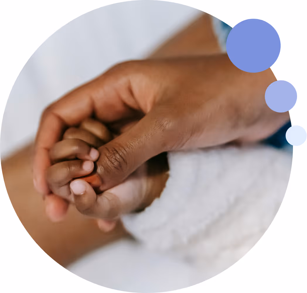 Parent holding newborn baby's hand – representing IVF and surrogacy financing support