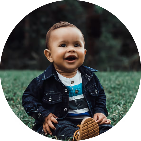 Smiling baby sitting on grass in call-to-action image for EggFund resources