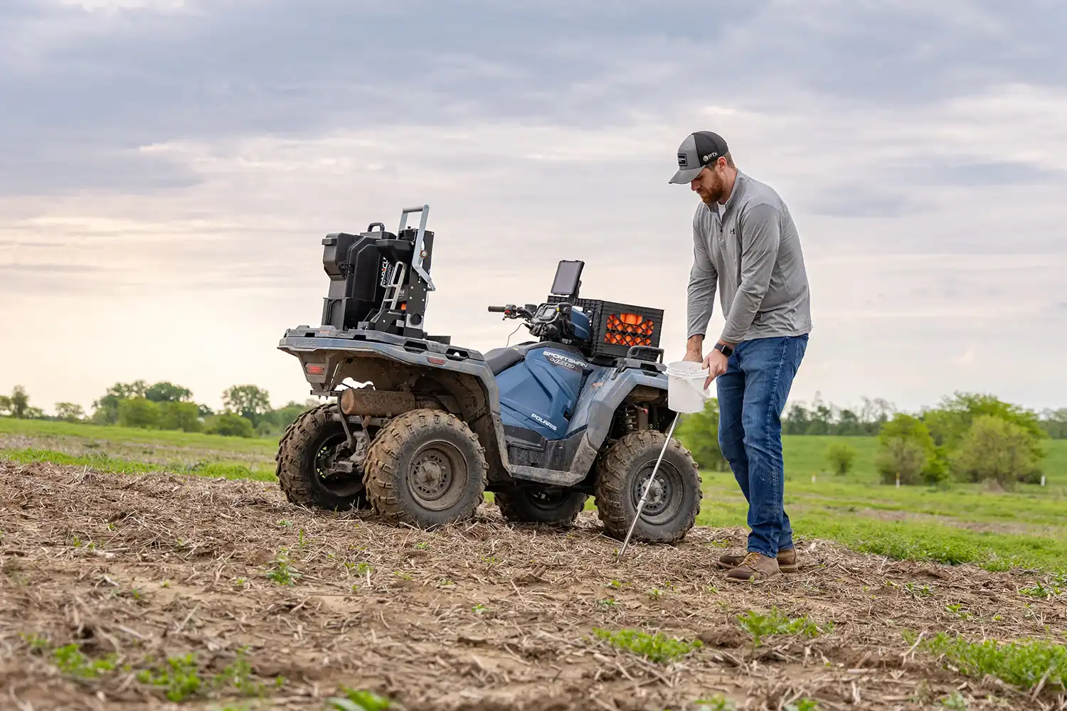 person collecting soil samples with GeoPress™ Lite by Radicle Ag
