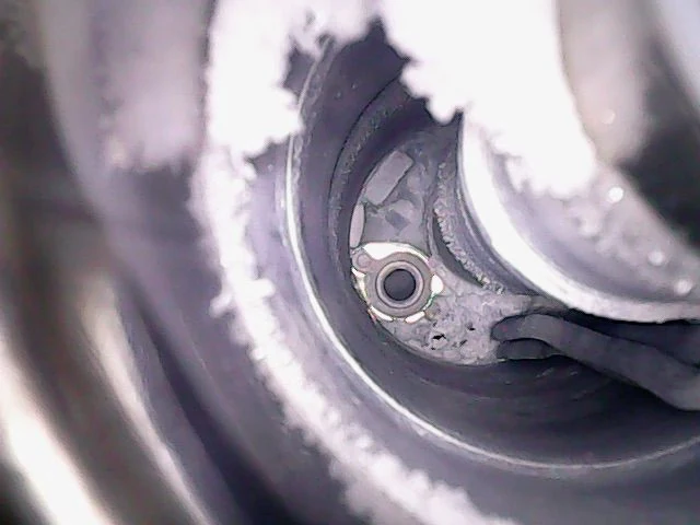 Internal camera view showing ice buildup within an MRI magnet cryogenic service path.