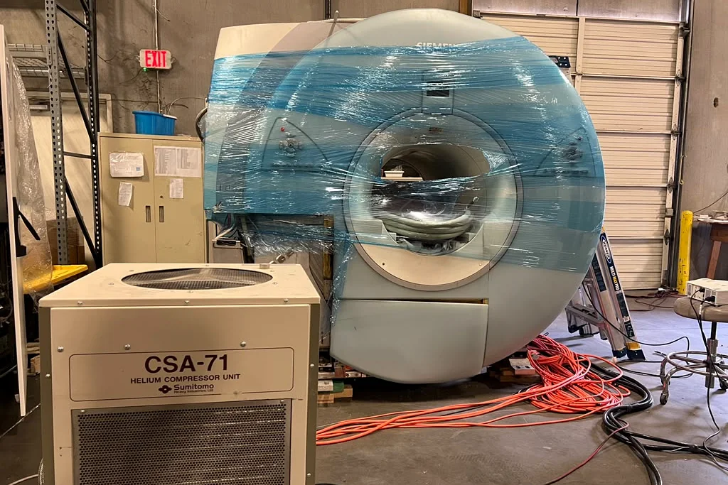 An MRI magnet connected to a helium compressor immediately after arrival at the Digit Systems warehouse for monitored cold storage.