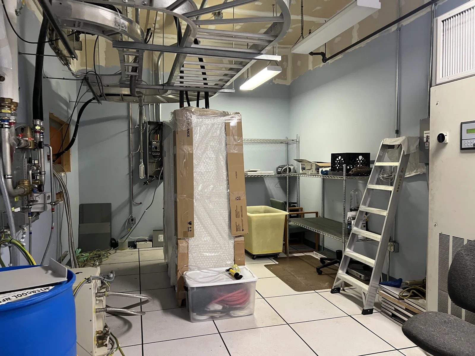 Wrapped MRI cabinets and packed components inside the equipment room during deinstallation in Bradford.