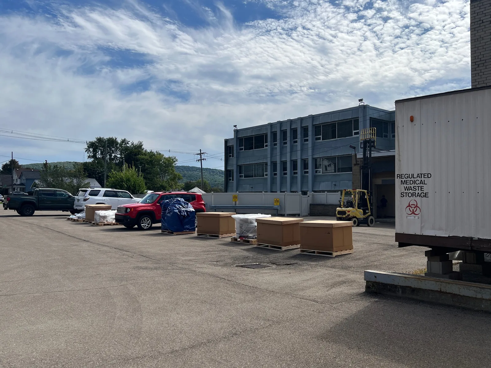 Crated MRI equipment staged outside the Bradford facility for removal.