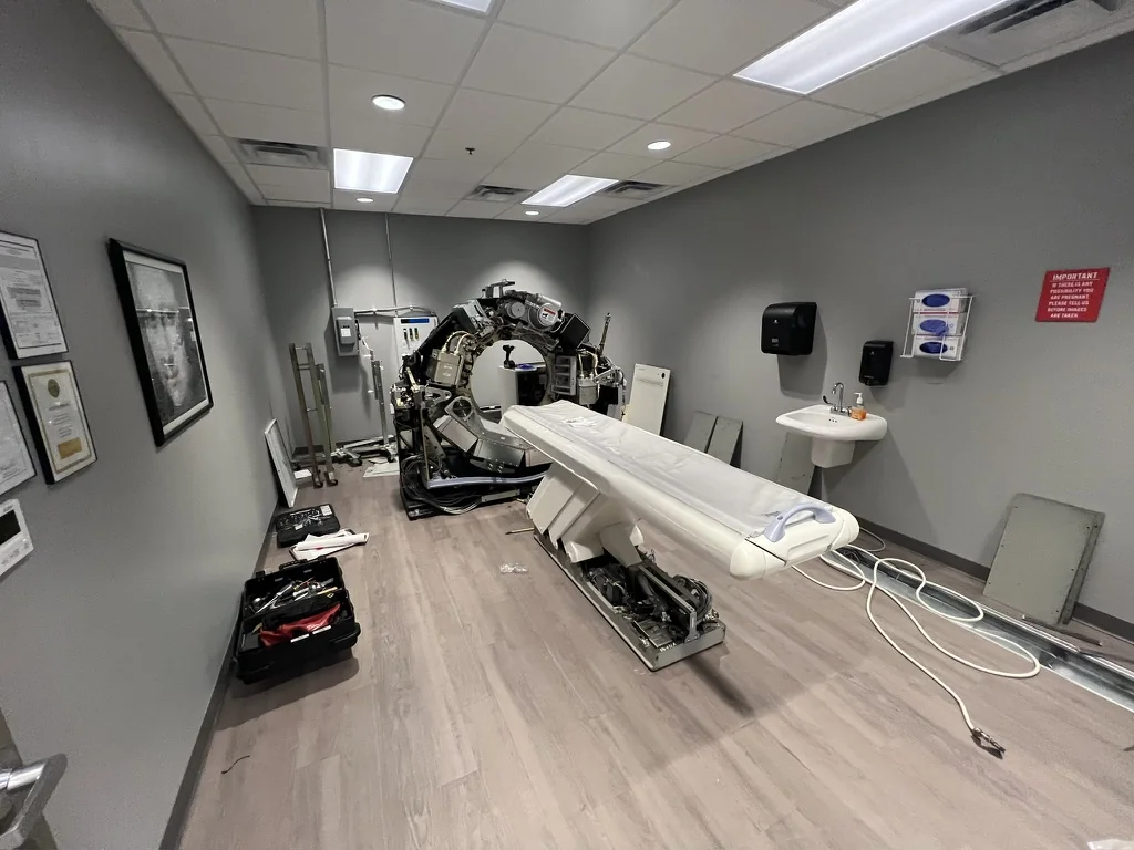 GE LightSpeed CT gantry with covers removed and patient table during deinstallation at Georgia Urology in Roswell.