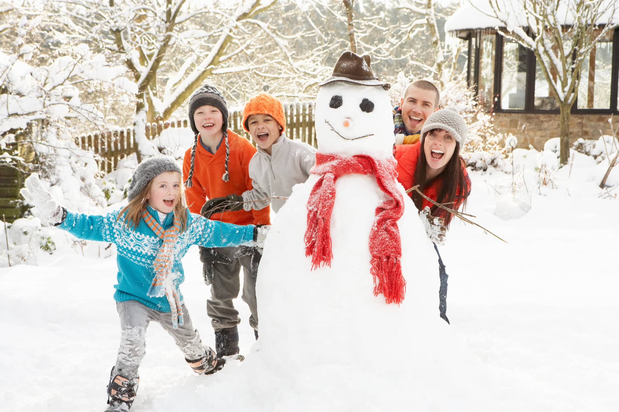 a family building a snowman 