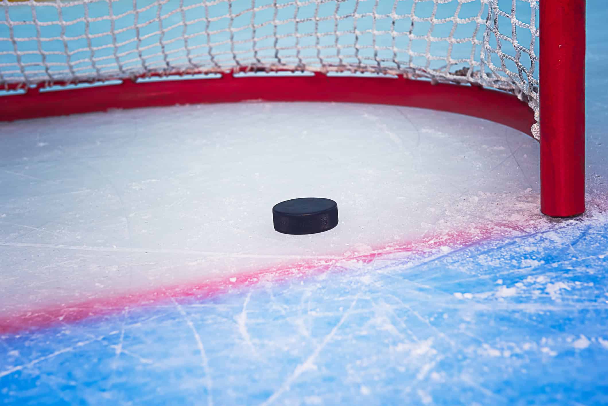 hockey puck entering goal net 