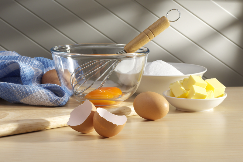 Baking Ingredients. Eggs, butter, sugar on kitchen bench ready for baking.