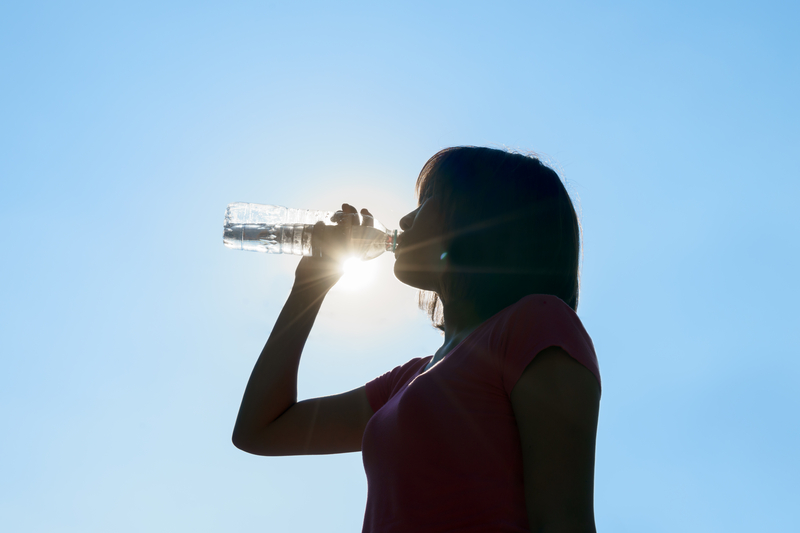 Female drinking water in hot summer