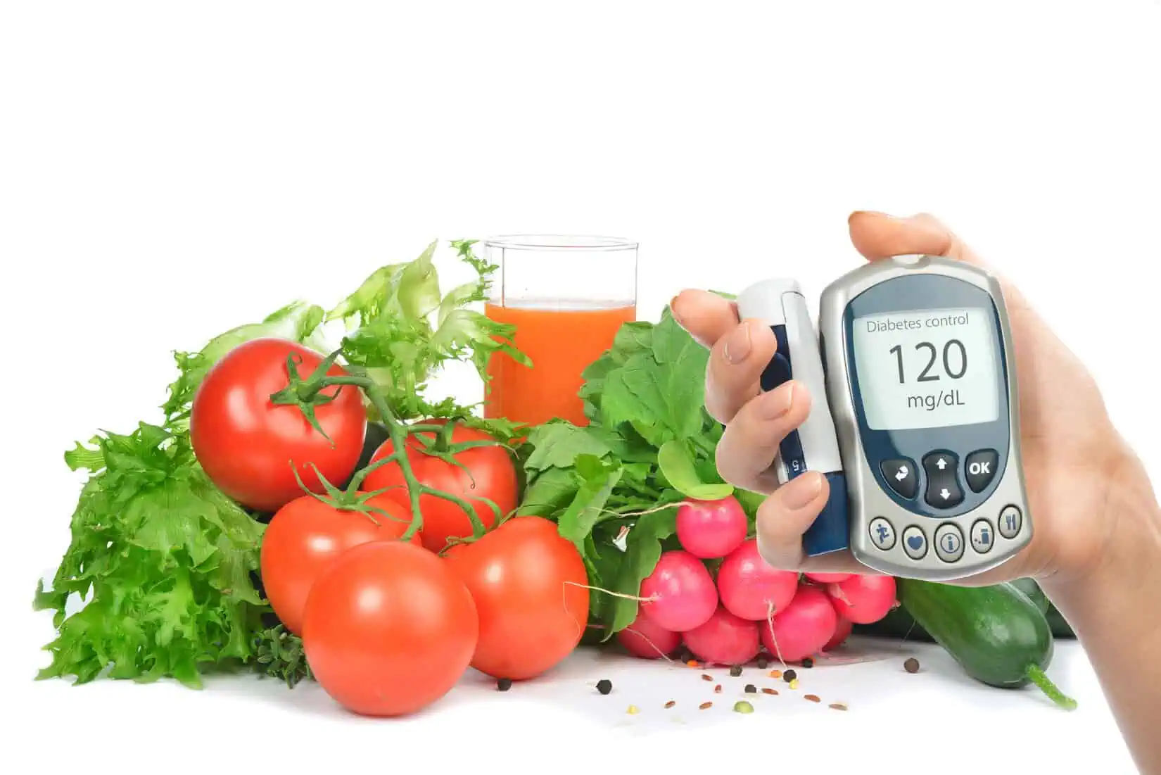 various vegetables piled behind a hand with a diabetes monitoring device
