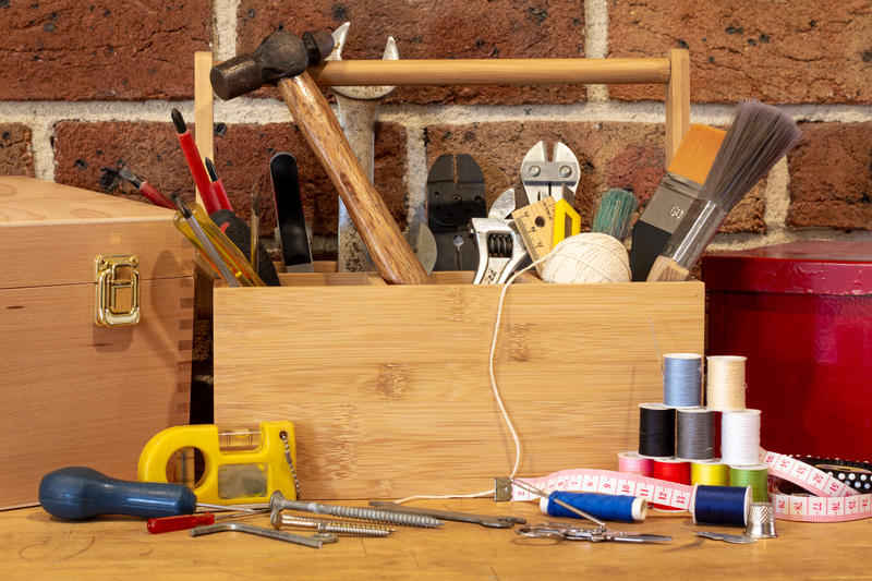 Tool box surrounded by repair tools on bench in cafe used as a community repair centre.