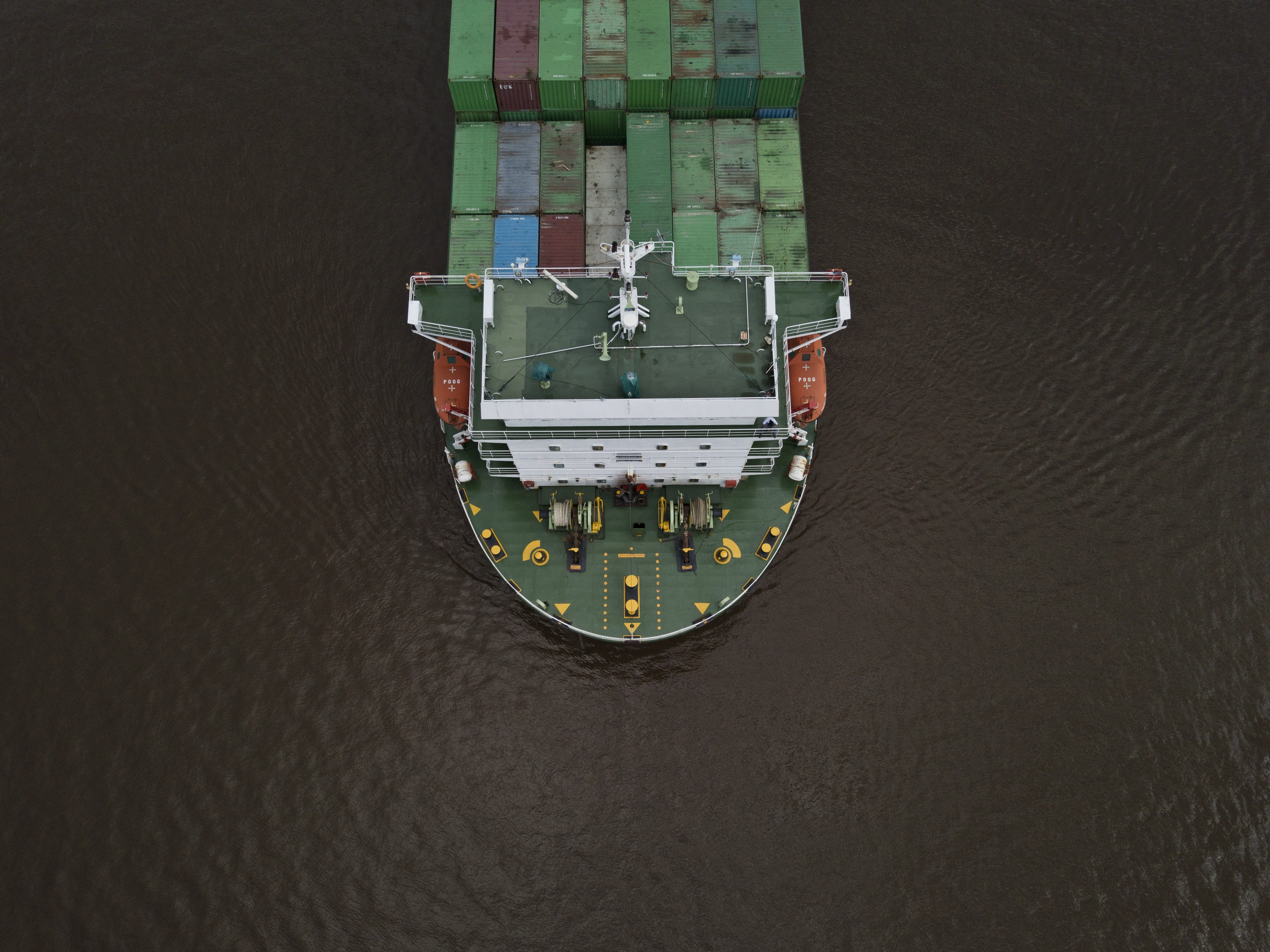 Birds eye view of a freight ship sailing on the ocean.
