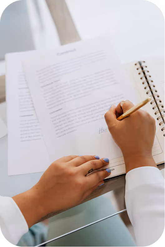 Pair of hands writing in a notebook
