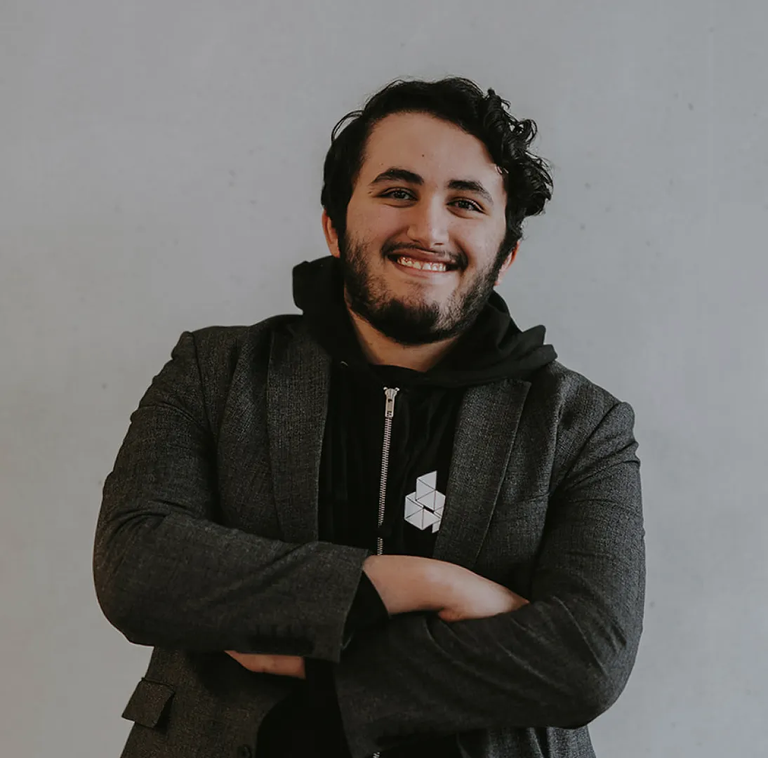 Man smiling with arms crossed