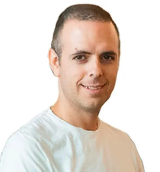 Portrait of a smiling man with short hair wearing a white shirt against a white background.