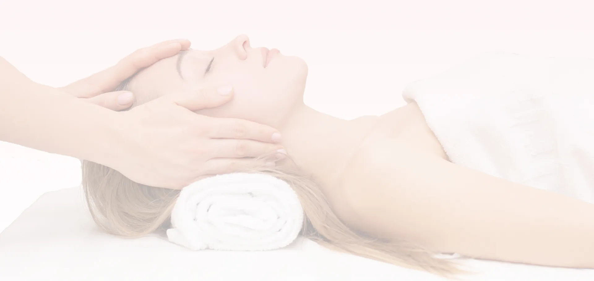a banner photo of a customer laying down on her back and receiving some treatment