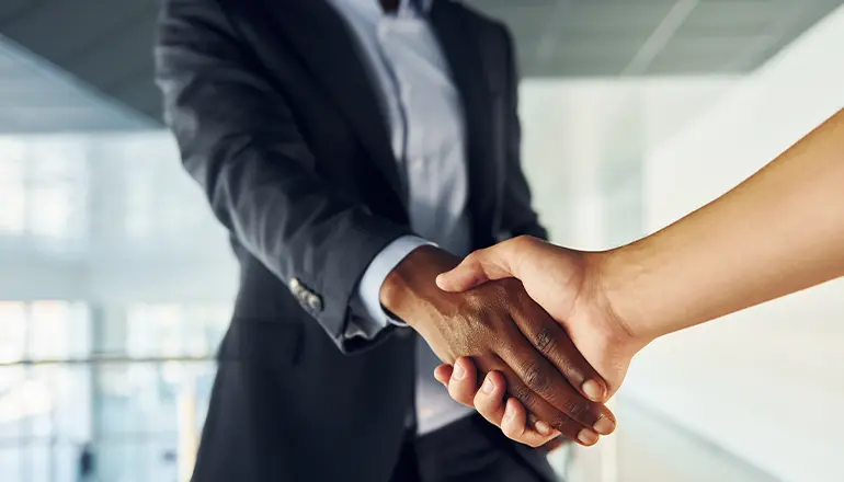 two  persons shaking hands each other