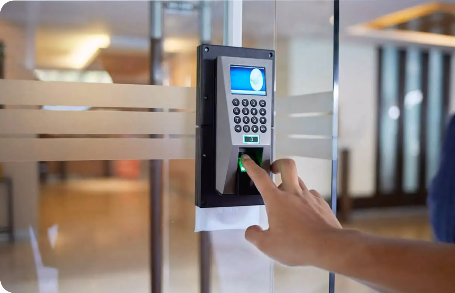 fingerprint scanner on an access control panel mounted on a glass door.