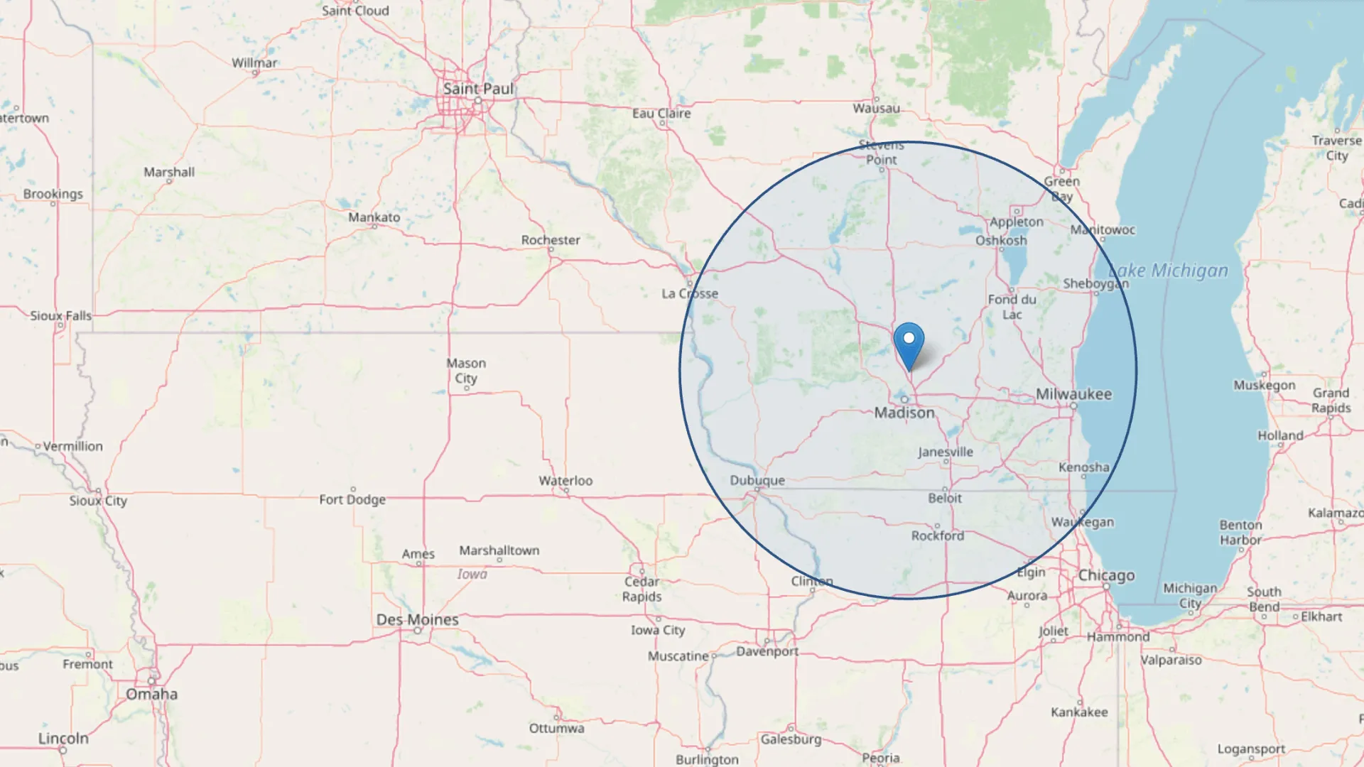 Map showing a 100-mile radius circle centered near Madison, Wisconsin, covering parts of southern Wisconsin, northern Illinois, and eastern Iowa.