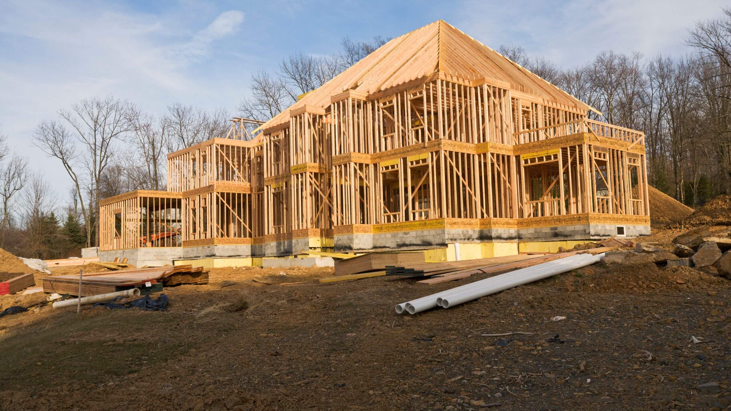 Fully framed two-story custom home with roof rafters complete