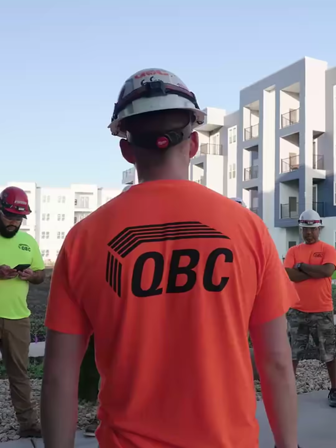 QBC crew huddle at a multifamily jobsite