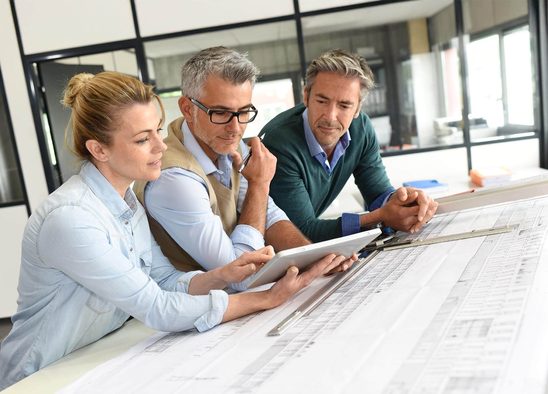 Architectural firm architects reviewing multi-family project plans and discussing value engineered options