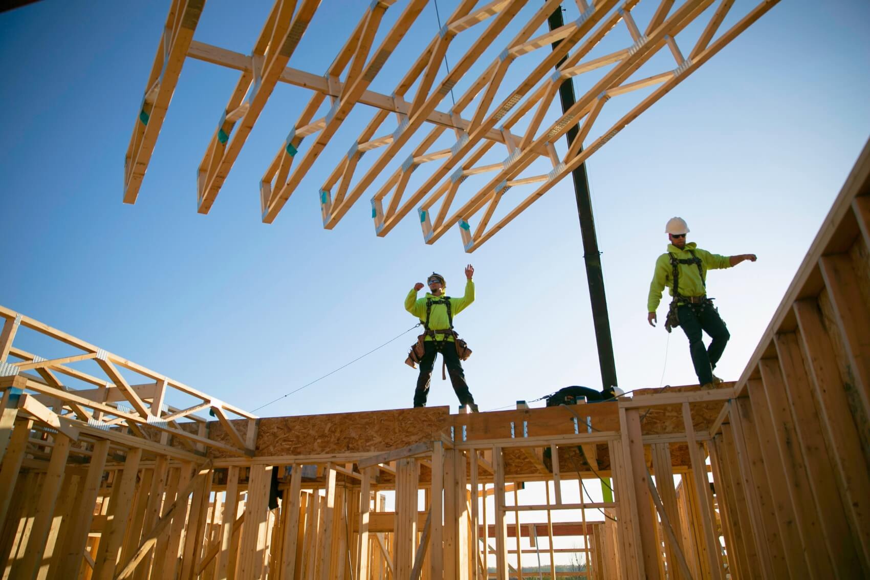QBC carpenters install roof trusses.
