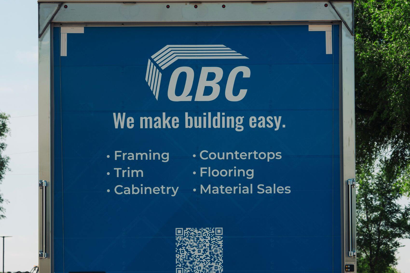The back of a QBC truck with a list of all of QBC's bundled services.