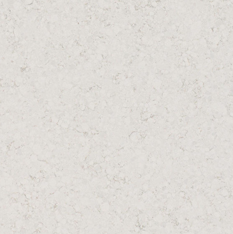 Closeup of One Quartz Golden Gate, white quartz with light gray speckling, available in QBC countertop packages